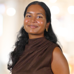 Moksha Visanagiri Moksha Visanagiri headshot in front of a blurred office background