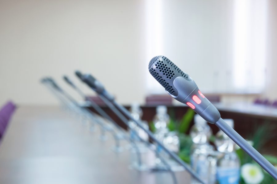 close up of a microphone in empty conference hall