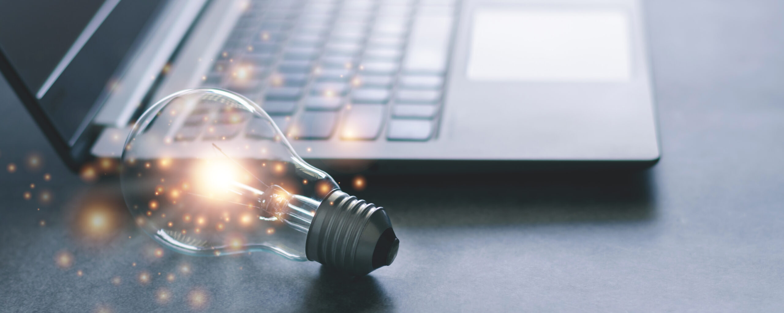 Laptop and glowing light bulb. Self learning or education knowledge and business studying concept. Idea of learning online or e-learning from home.